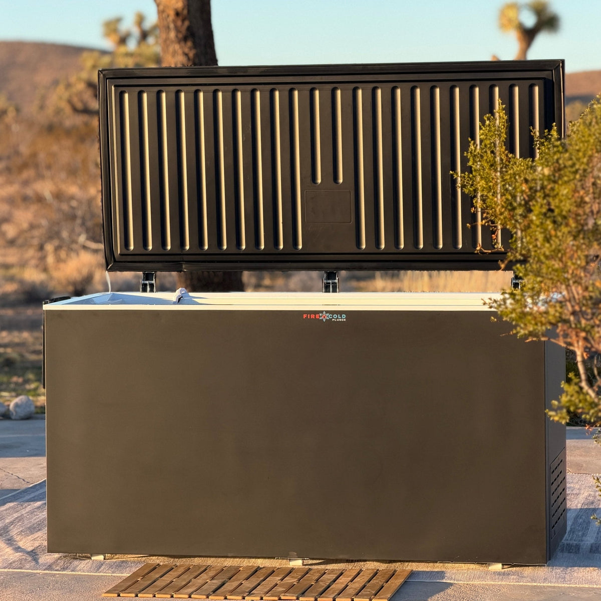 Fire Cold Plunge All-In-One Residential with its hard lid open on an outdoor patio