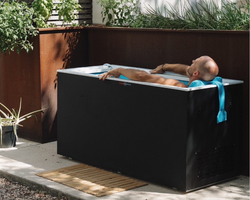 A person reclining in a Fire Cold Plunge